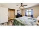 This bedroom features stylish gray wood floors, a modern fan, and a brightly lit closet for ample storage space at 335 Simon Bolivar Dr, Henderson, NV 89014