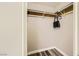 Walk-in closet with built-in shelving and ample storage space with a grey wood-look floor at 335 Simon Bolivar Dr, Henderson, NV 89014