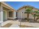 Charming single-story home featuring desert landscaping, a two-car garage, and a quaint front entryway at 335 Simon Bolivar Dr, Henderson, NV 89014