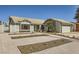 Single-story home featuring desert landscaping, a two-car garage, and a quaint front entryway at 335 Simon Bolivar Dr, Henderson, NV 89014