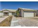 Charming single-story home featuring desert landscaping, a two-car garage, and a quaint front entryway at 335 Simon Bolivar Dr, Henderson, NV 89014