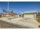 Single-story home with a two-car garage, desert landscaping, and a quaint front entryway at 335 Simon Bolivar Dr, Henderson, NV 89014