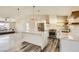 A kitchen featuring stainless steel appliances, a waterfall countertop, and adjacent living area at 335 Simon Bolivar Dr, Henderson, NV 89014