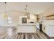 Bright kitchen featuring stainless steel appliances, white cabinets, and quartz countertops with floating shelves at 335 Simon Bolivar Dr, Henderson, NV 89014