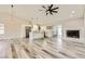 Living area featuring an open floorplan with luxury flooring, a fireplace, and a modern kitchen at 335 Simon Bolivar Dr, Henderson, NV 89014