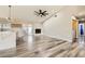An open floorplan with a modern kitchen, fireplace, and sliding glass doors at 335 Simon Bolivar Dr, Henderson, NV 89014