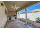 Covered patio with outdoor kitchen and built-in grill, perfect for entertaining with a modern ceiling fan at 335 Simon Bolivar Dr, Henderson, NV 89014