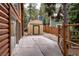 A view of the backyard with a shed and fence, surrounded by large trees and greenery at 401 Alpine Way, Las Vegas, NV 89124