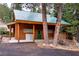Log cabin with covered porch, woodpile, and green door for a cozy, rustic feel at 401 Alpine Way, Las Vegas, NV 89124