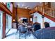 Cozy living space with log walls, a soaring ceiling, and a rustic staircase at 401 Alpine Way, Las Vegas, NV 89124