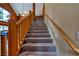 Carpeted staircase with rustic wood railing and natural light at 401 Alpine Way, Las Vegas, NV 89124