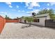 A spacious low maintenance backyard with desert landscaping, surrounded by a brick wall and wood fence at 404 Vassar Ln, Las Vegas, NV 89107