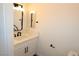 Bathroom with vanity, white cabinet, marble countertop, and modern black faucet at 404 Vassar Ln, Las Vegas, NV 89107