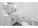 Bright bathroom featuring a modern vanity with black fixtures and a sleek, square mirror at 404 Vassar Ln, Las Vegas, NV 89107