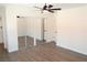 Bedroom showcases hard surface floors, closet with mirrored doors, and modern ceiling fan at 404 Vassar Ln, Las Vegas, NV 89107