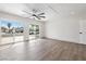 Spacious bedroom with new floors, a ceiling fan, and sliding glass doors to the backyard at 404 Vassar Ln, Las Vegas, NV 89107