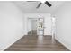 Bright bedroom featuring wood floors, a ceiling fan, and a large mirrored closet at 404 Vassar Ln, Las Vegas, NV 89107