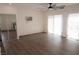This bedroom features wood floors, a ceiling fan, a closet with sliding mirrored doors, and sliding glass doors at 404 Vassar Ln, Las Vegas, NV 89107