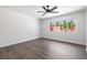 Bright bedroom featuring wood floors, a ceiling fan, and a large window that brightens the space at 404 Vassar Ln, Las Vegas, NV 89107