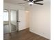 Bright bedroom featuring hard surface floors, ceiling fan, and closet with mirrored doors at 404 Vassar Ln, Las Vegas, NV 89107