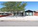 Charming single-story home featuring a well-maintained front yard with mature shade tree at 404 Vassar Ln, Las Vegas, NV 89107