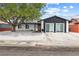 Charming single-story home with desert landscaping, a mature shade tree, and a two-car driveway at 404 Vassar Ln, Las Vegas, NV 89107