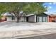 Charming single-story home with desert landscaping, a mature shade tree, and a two-car driveway at 404 Vassar Ln, Las Vegas, NV 89107