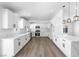 Spacious kitchen featuring white cabinetry, marble countertops, and modern pendant lighting at 404 Vassar Ln, Las Vegas, NV 89107