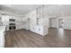 A bright updated kitchen features white cabinets, countertops, and modern appliances with updated lighting at 404 Vassar Ln, Las Vegas, NV 89107