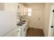 The kitchen has ample storage, sleek white cabinets, and modern countertops at 404 Vassar Ln, Las Vegas, NV 89107