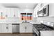 Bright, upgraded kitchen with stone countertops, stainless steel appliances, and modern cabinetry at 404 Vassar Ln, Las Vegas, NV 89107