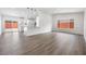 Spacious open floor plan with light gray wood floors and updated lighting at 404 Vassar Ln, Las Vegas, NV 89107