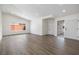 Spacious living room with light gray wood floors, updated lighting, and a view to the backyard at 404 Vassar Ln, Las Vegas, NV 89107