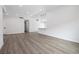 Spacious living room with light gray wood floors, recessed lighting, and modern fixtures at 404 Vassar Ln, Las Vegas, NV 89107