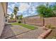 Backyard featuring synthetic grass, hardscape and block wall at 4176 Demoline Cir, Las Vegas, NV 89141