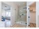 Bathroom featuring a glass enclosed shower with black hardware, a window seat, and walk-in closet entrance at 4176 Demoline Cir, Las Vegas, NV 89141