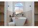 Bathroom showing soaking tub with a window view and entrances to separate closets at 4176 Demoline Cir, Las Vegas, NV 89141