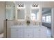 This bathroom features a double sink vanity with lit mirrors and gold hardware at 4176 Demoline Cir, Las Vegas, NV 89141