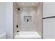Modern bathroom with a tub and decorative tile surround at 4176 Demoline Cir, Las Vegas, NV 89141