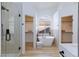 Bright bathroom featuring a soaking tub, glass enclosed shower, and access to the and walk-in closets at 4176 Demoline Cir, Las Vegas, NV 89141