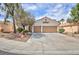 Inviting single-Gathering home with a two-car garage, desert landscaping, mature trees, and concrete driveway at 4176 Demoline Cir, Las Vegas, NV 89141