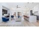 Open-concept living room boasts modern fireplace, ceiling fan, and seamless flow into kitchen and dining area at 4176 Demoline Cir, Las Vegas, NV 89141