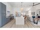 Spacious open-concept, featuring white walls, dining area, gourmet kitchen with large island and modern fireplace at 4176 Demoline Cir, Las Vegas, NV 89141