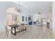 Inviting living space featuring modern chandelier over dining table and open flow to the living room and kitchen at 4176 Demoline Cir, Las Vegas, NV 89141