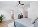This bedroom features a ceiling fan, light hardwood floors, and a wet bar that leads to a private bathroom at 4176 Demoline Cir, Las Vegas, NV 89141