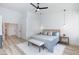 Bright and airy main bedroom with bench and neutral decor at 4176 Demoline Cir, Las Vegas, NV 89141