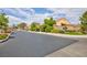 Gated community entrance with lush landscaping and decorative stone wall at 4176 Demoline Cir, Las Vegas, NV 89141