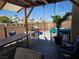 Backyard patio with gazebo, swing, table, and pool at 4612 Supreme Ct, Las Vegas, NV 89110