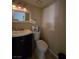 Cozy powder room with pedestal sink, toilet, framed mirror and neutral decor at 4612 Supreme Ct, Las Vegas, NV 89110