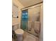 Bathroom featuring a toilet and tiled shower with sliding glass doors and patterned towels at 4612 Supreme Ct, Las Vegas, NV 89110